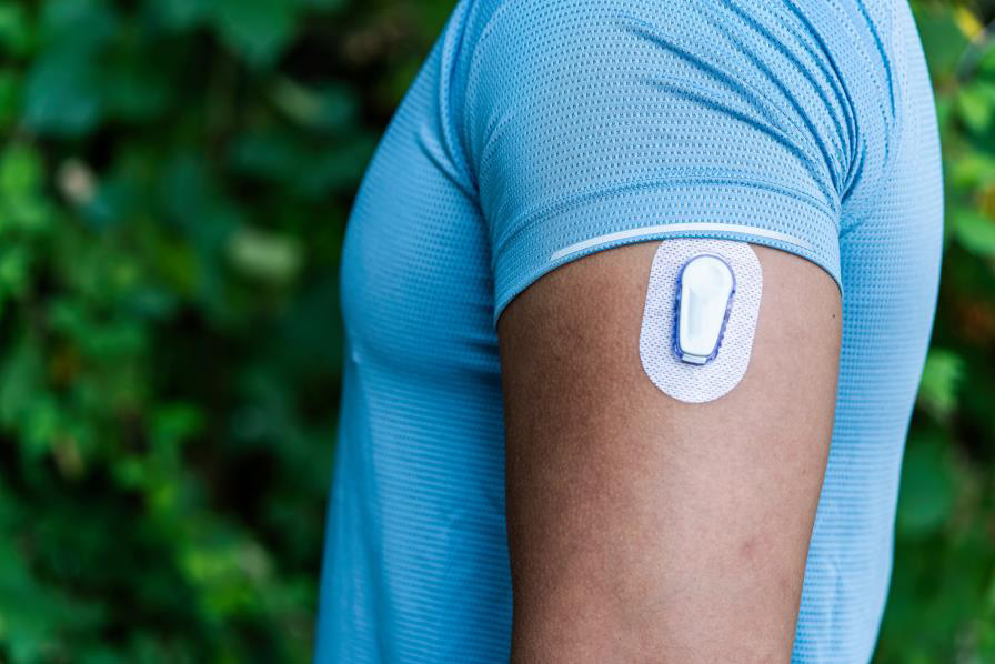 man wearing CGM device